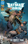 Comic book cover featuring Batman and Robin with text 'Batman and Robin vs. The Quiet Man' on a blue background.