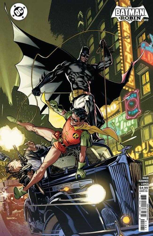 Comic book cover featuring Batman and Robin in an urban setting with neon lights.
