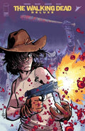 Comic book cover of 'The Walking Dead Deluxe' with a character holding a gun amidst blood and zombies.