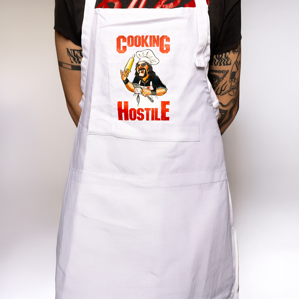 White apron with a graphic design and text worn by a person against a white background